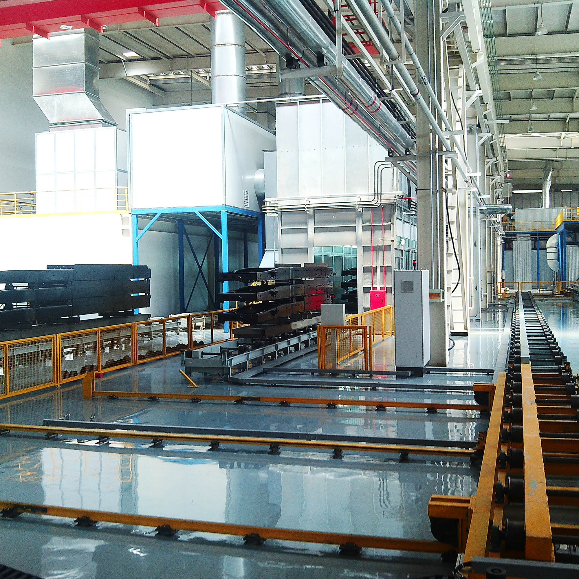 Industrial hall with VOC treatment ductwork and equipment integrated above a coating line